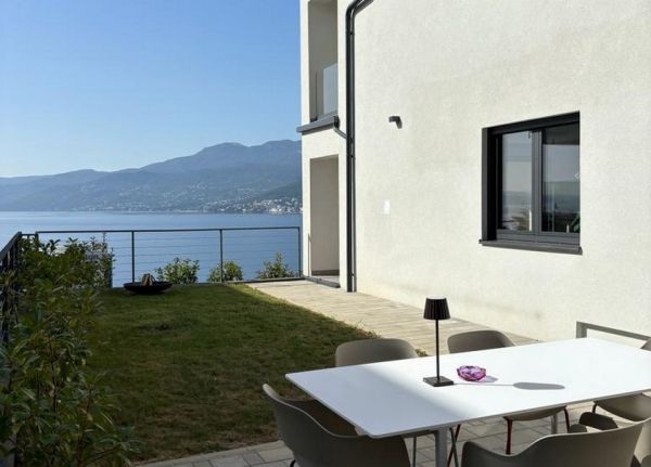 Terrace with white table and chairs overlooking the sea, apartment for sale in Rijeka, Croatia.
