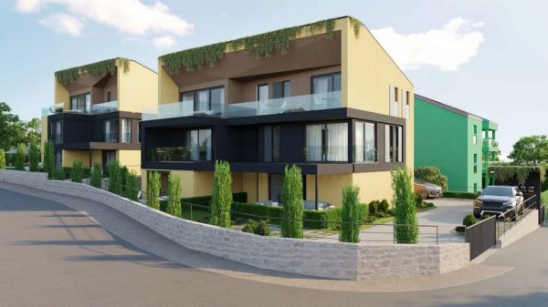 Exterior view of modern apartments in Croatia, Krk island, with yellow and brown tones, green roofs, glass balconies and a paved driveway