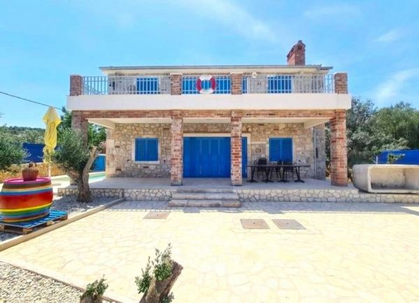 Traditional Dalmatian stone house for sale in Croatia with blue shutters and spacious terrace