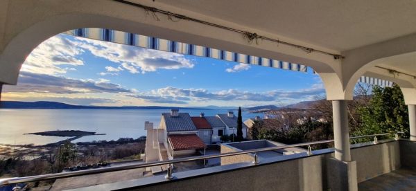 View from a covered terrace of the sea in Croatia, house for sale with striped awning and panorama
