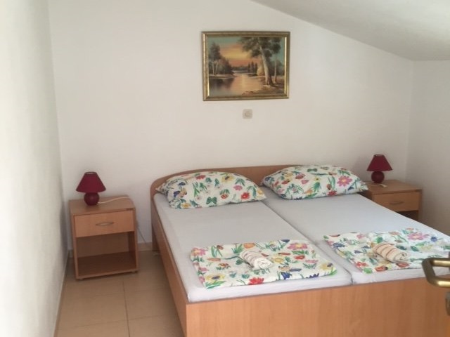 One bedroom of the attic apartment with double bed in South Dalmatia.
