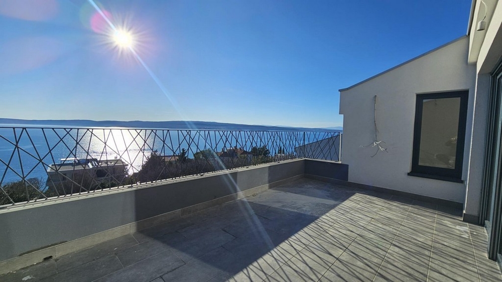 Spacious and sunny balcony overlooking the sea in an apartment in Crikvenica, showing calm water and horizon
