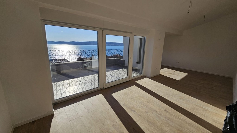 View from inside the living area of ​​an apartment for sale in Crikvenica, highlighted by the balcony and expansive sea views