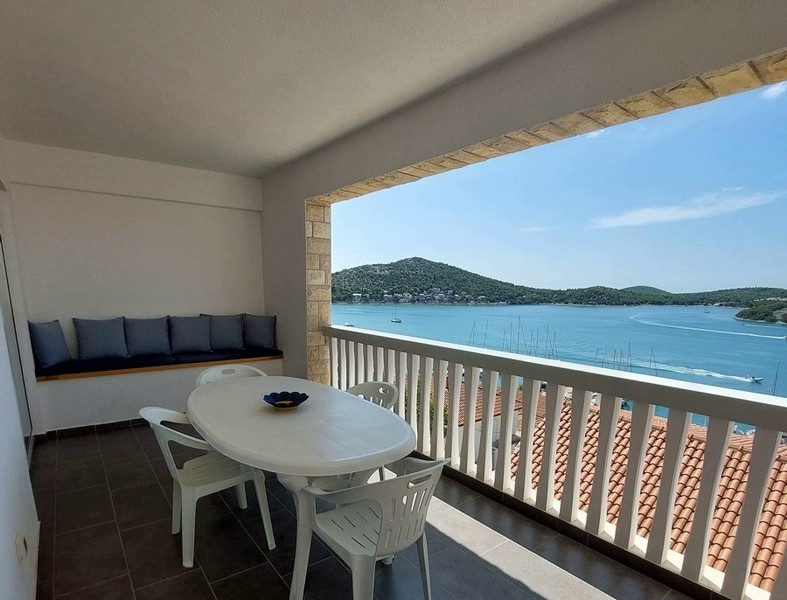 Covered terrace with garden furniture of the apartment for sale near the sea in Croatia.