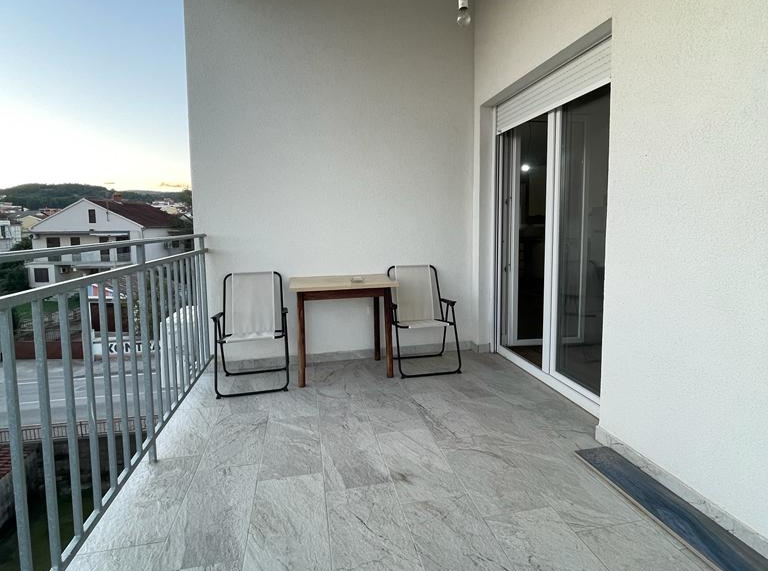 Terrace of the attic apartment for sale in Croatia, with chairs and table, ready for relaxing evenings