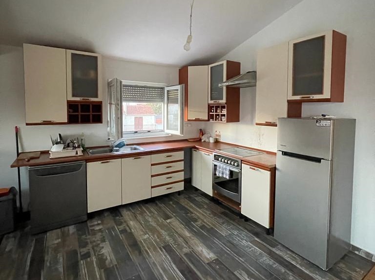Modern kitchen for sale in an apartment in Vodice, Croatia, with built-in appliances and plenty of storage space.