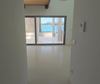 Real Estate Croatia - Contemporary penthouse with minimalist design, clean lines and large sliding glass doors to the balcony, offered by Panorama Scouting.