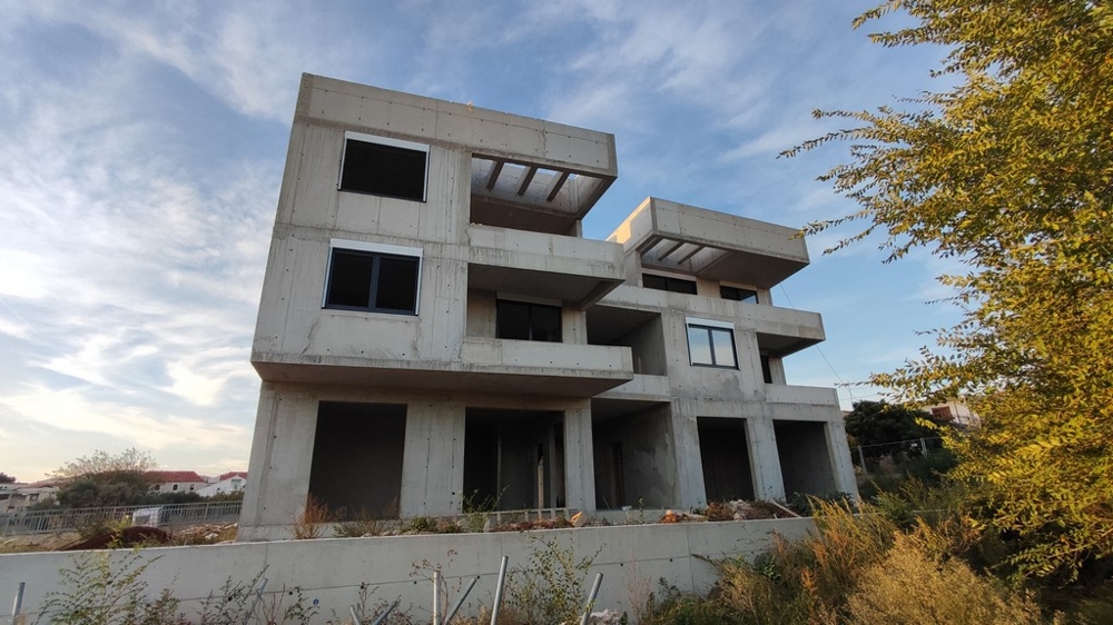 Architectural side view of an apartment block under construction in Tribunj, Vodice, highlighting the modern living spaces for sale.