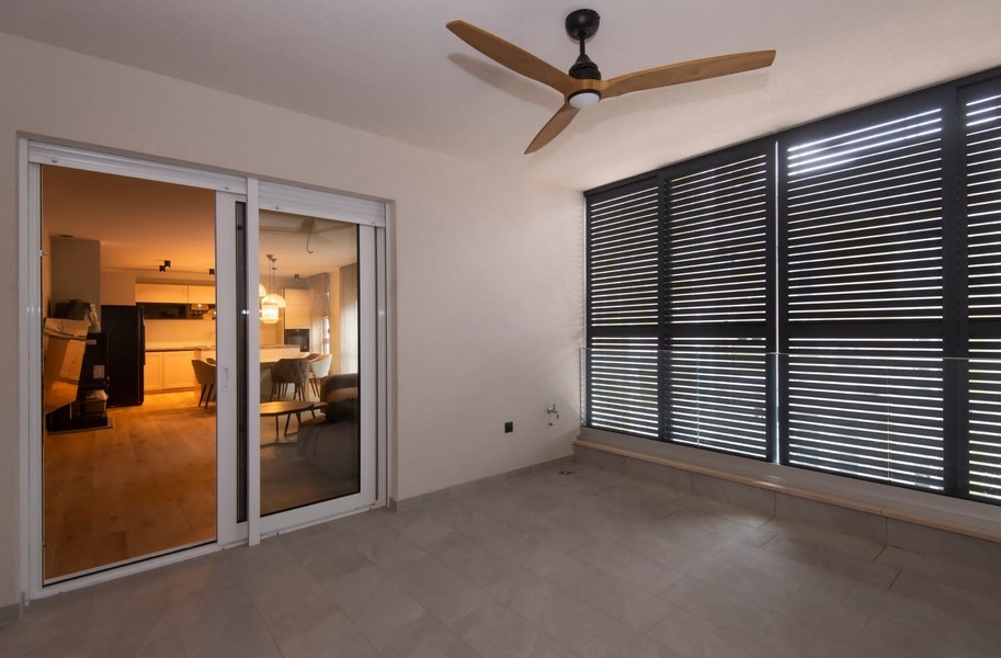View from the balcony of a modern apartment for sale in Split, Croatia, with sliding doors and contemporary design.