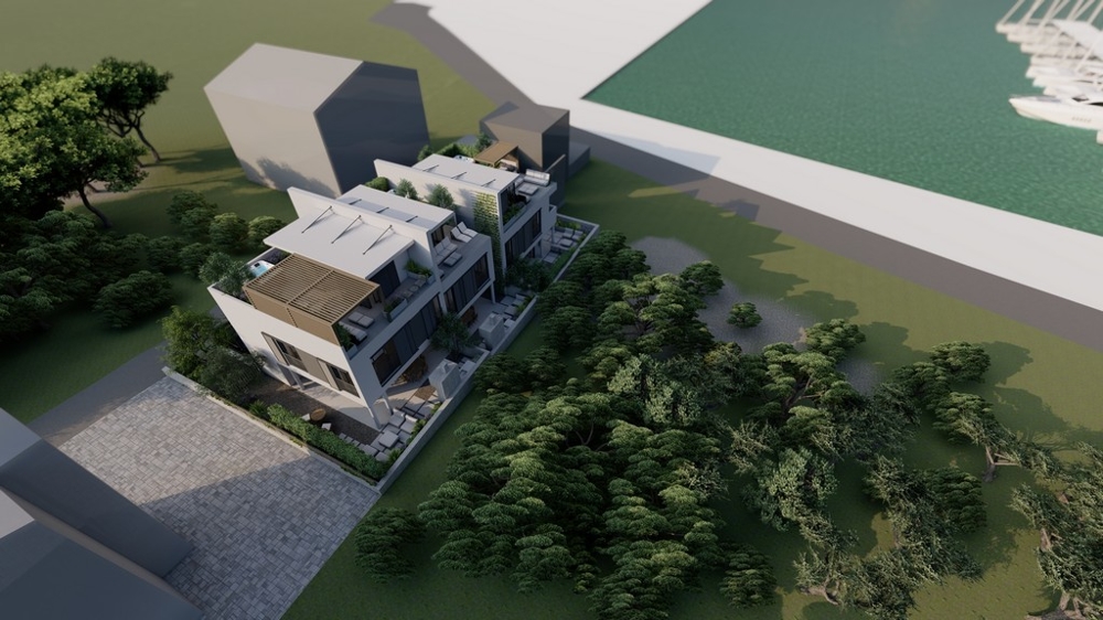 Angle view of a stylish property in Croatia surrounded by trees and landscaped gardens.
