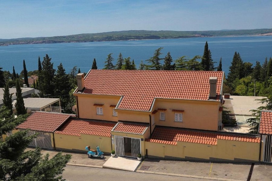 Aerial view of a property in Croatia with sea views and surrounded by trees