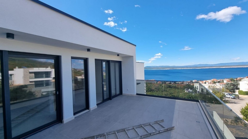 Terrace of a modern apartment in Croatia with a view of the sea and clear sky.