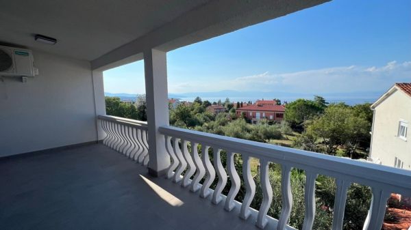 View from the white balcony terrace of a property in Croatia of the sea and the surrounding houses in Malinska