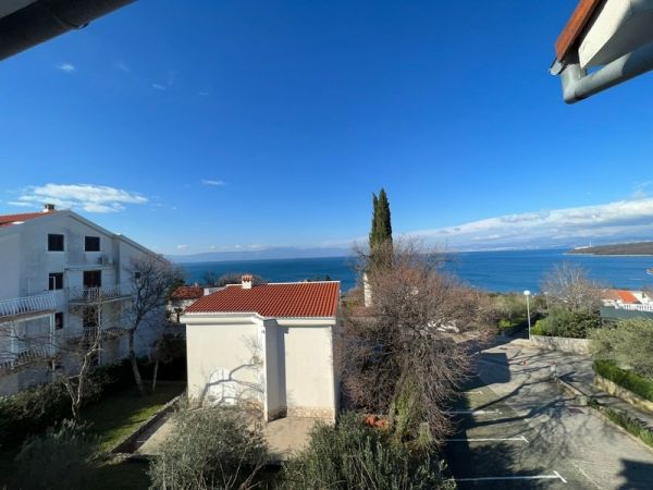 View from a balcony of the property on the island of Krk to the calm sea and the coast of Njivice.