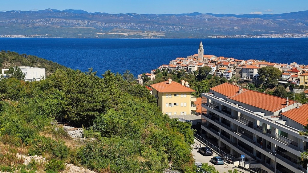 Old town of Vrbnik with church tower in front of the sea, location of apartment A3481 on the island of Krk
