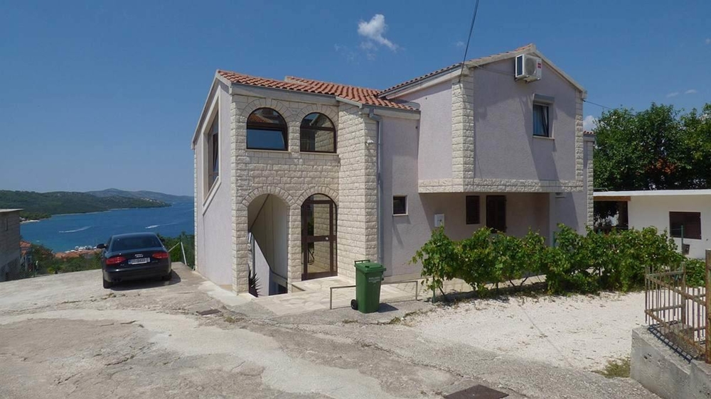 The apartment house for sale on Ciovo, Croatia is decorated in stone house style.