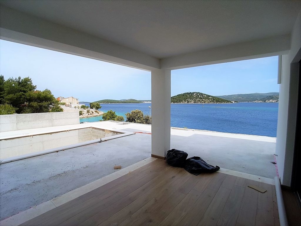 View from the covered terrace to the swimming pool and the sea - villa for sale Croatia.
