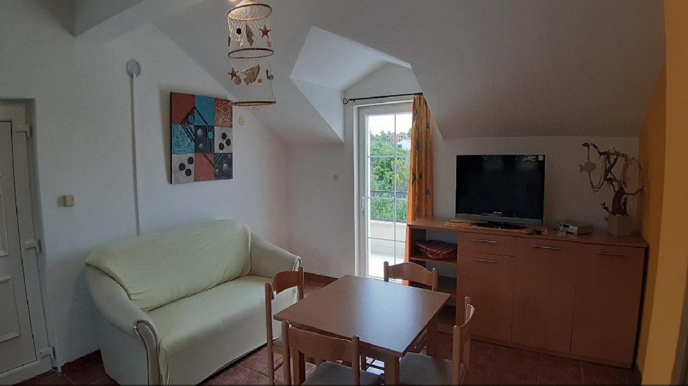 A living room with exit to the balcony of the property H1189 on the island of Solta.