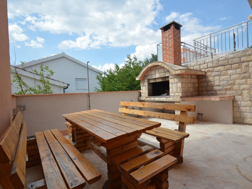 Outside area with barbecue grill and dining area.