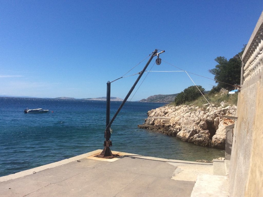 Bathing platform with boat crane in front of the house H1392 in Croatia.