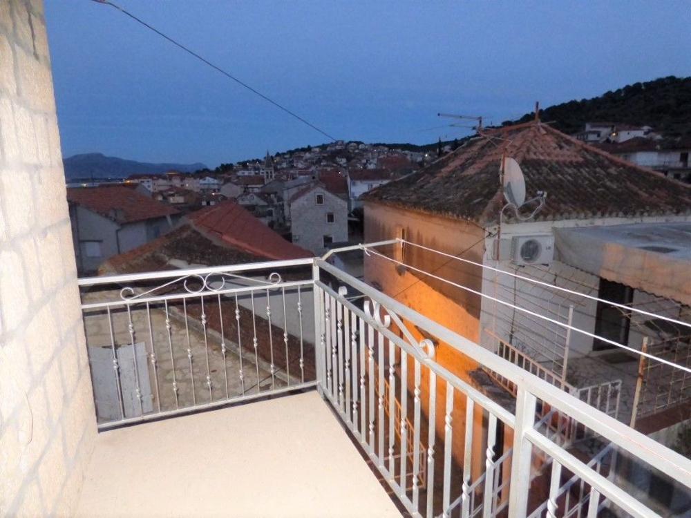 Balcony with a view of the roofs of Trogir.