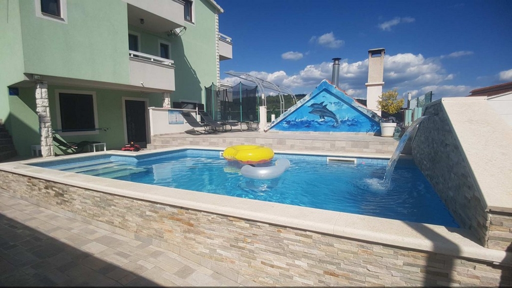 View of the swimming pool and the back of the house from the lounge area