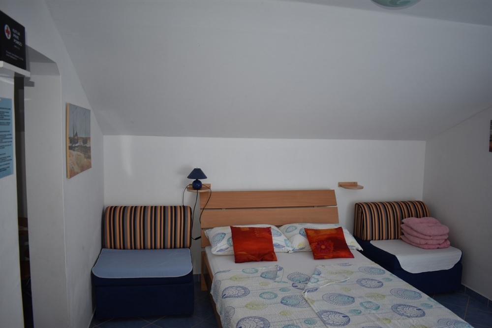 A bedroom with a window in the Zadar region
