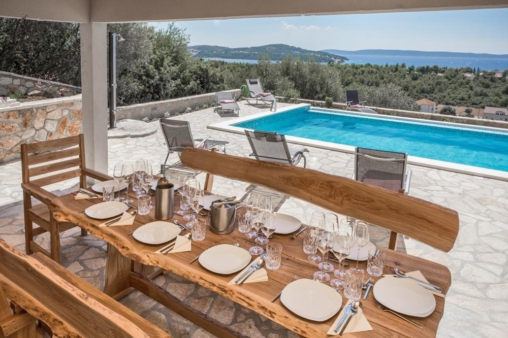 View from the dining area on the terrace overlooking the pool and sea.