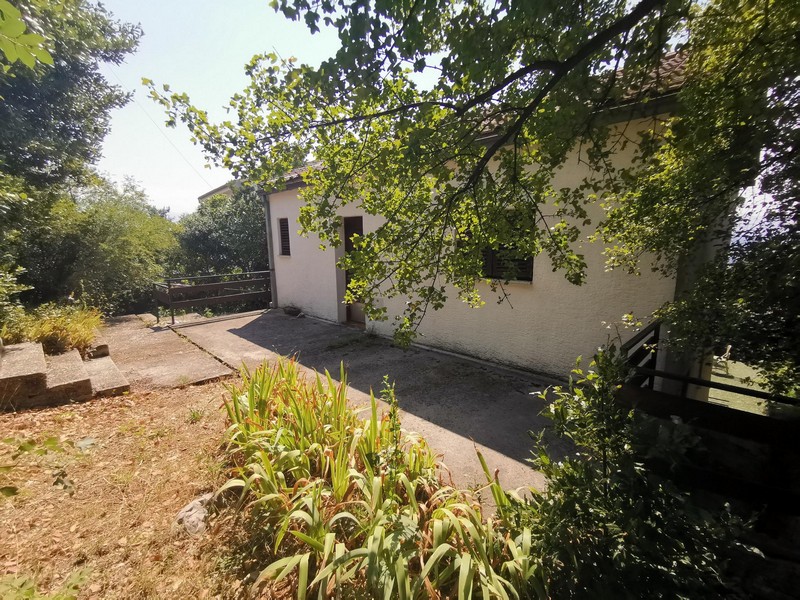 View of the entrance of the house with a view of the garden and the surrounding area - buy a house in Croatia.