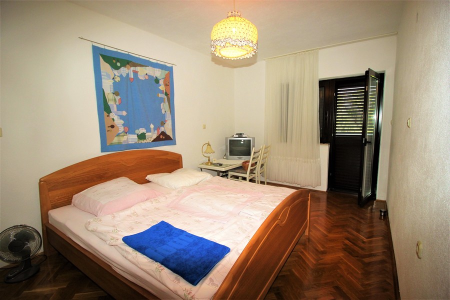 One bedroom of the property with double bed and exit to the balcony.