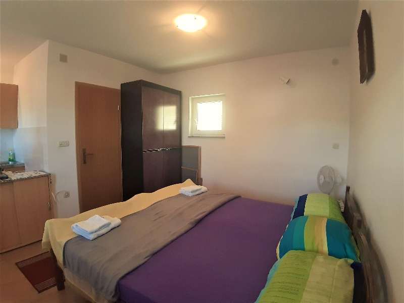 Another bedroom with double bed and kitchen - Buy a house in Croatia.