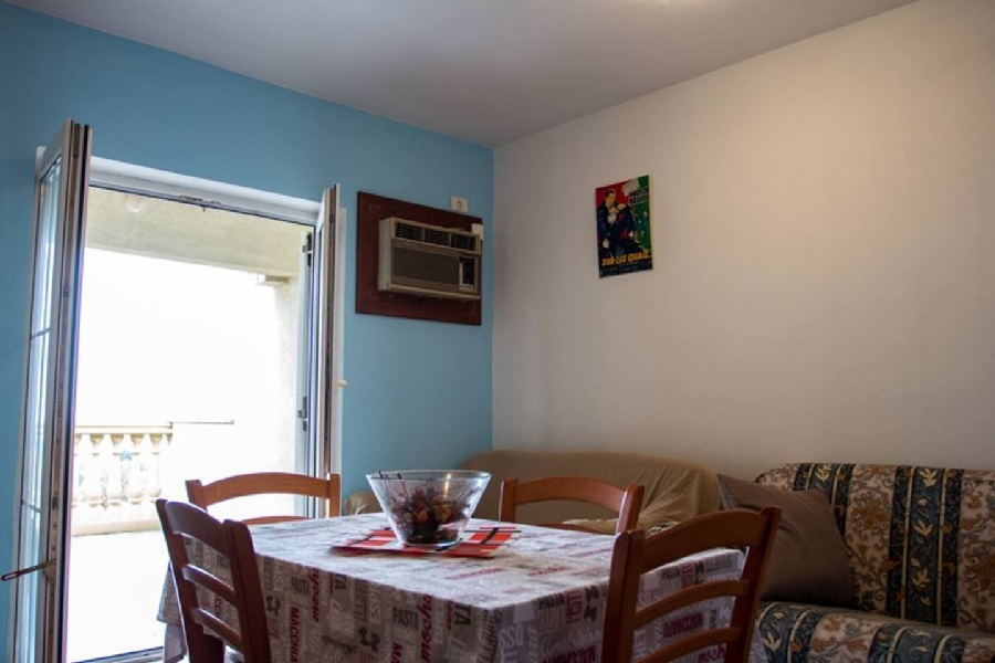 A dining and living area of ​​an apartment with exit to the balcony - Buy a house in Croatia.