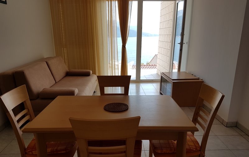 Dining and living area of ​​the apartment on the ground floor of the property for sale on Korcula, Croatia.
