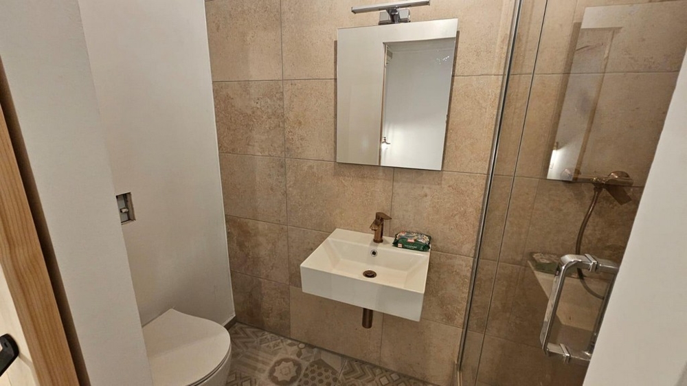 Modern bathroom with walk-in shower and minimalist design