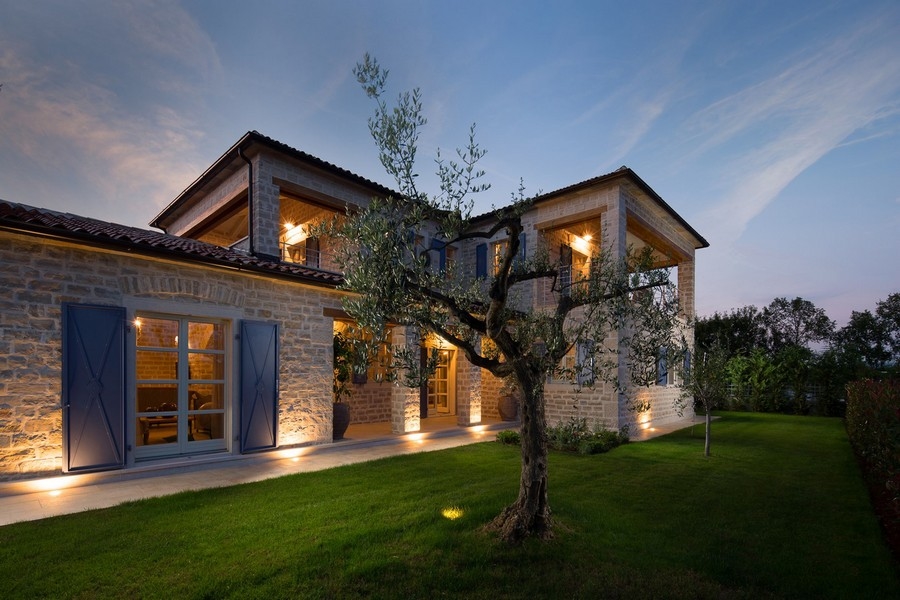 Luxurious Croatian villa with illuminated exterior, stone walls and blue shutters at dusk, listed as Villa Buy Croatia H2878
