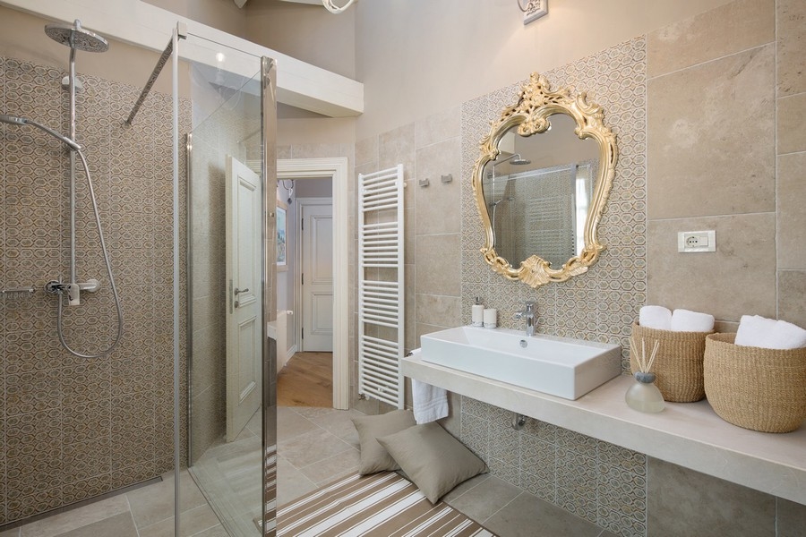 Elegant bathroom with walk-in shower, mosaic tiles and bench - Real Estate Croatia