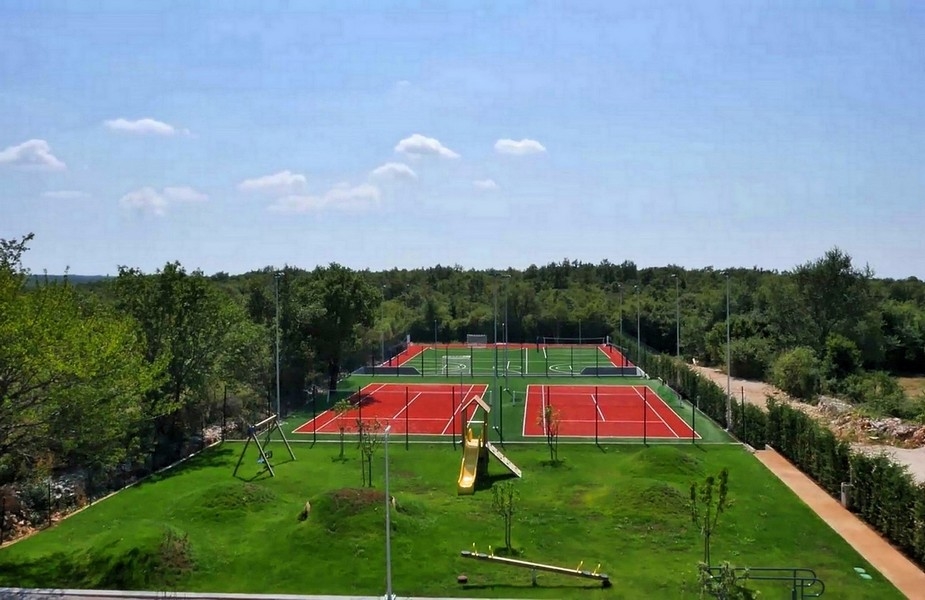 View of tennis courts and outdoor play area surrounded by forest - Villa for sale Croatia H2879