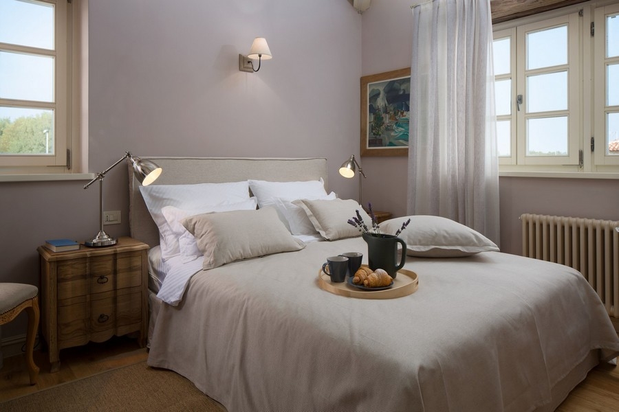 Inviting bedroom with comfortable bed linen, bedside lamps and a breakfast tray on the bed - Real Estate Croatia