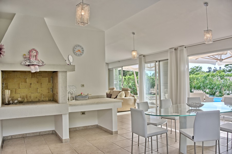 Open plan living and dining area with fireplace in a seaside villa in Istria.