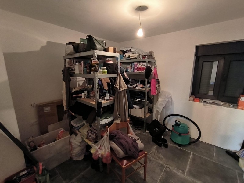 Overcrowded storage rack in a room of the property in Croatia, shows need for renovation